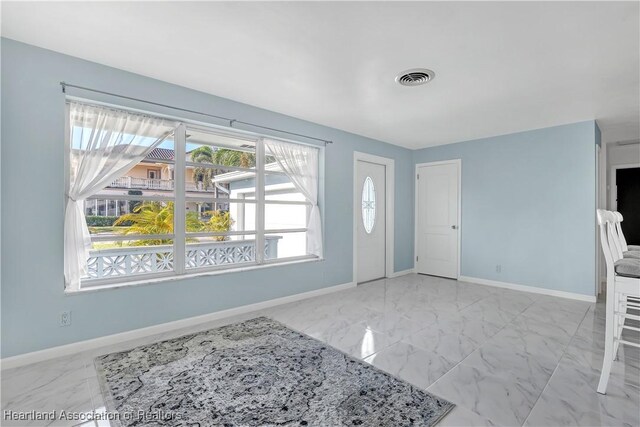 115 Elwa Pl, West Palm Beach, FL 33405 - entryway featuring marble finish floors and baseboards