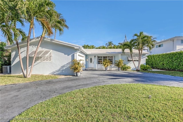115 Elwa Pl, West Palm Beach, FL 33405 - single story home featuring asphalt driveway, stucco siding, a garage, and a front lawn