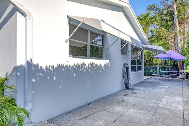 115 Elwa Pl, West Palm Beach, FL 33405 - view of property exterior featuring stucco siding and a patio area
