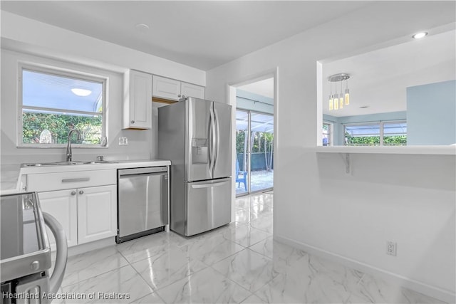 115 Elwa Pl, West Palm Beach, FL 33405 - kitchen with appliances with stainless steel finishes, light countertops, and plenty of natural light
