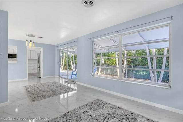 115 Elwa Pl, West Palm Beach, FL 33405 - unfurnished living room featuring light marble finish floors and baseboards