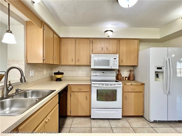 kitchen with sink, a textured ceiling, decorative light fixtures, white appliances, and light tile patterned floors