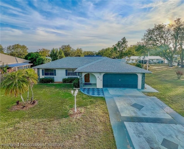 ranch-style home with a garage and a front yard