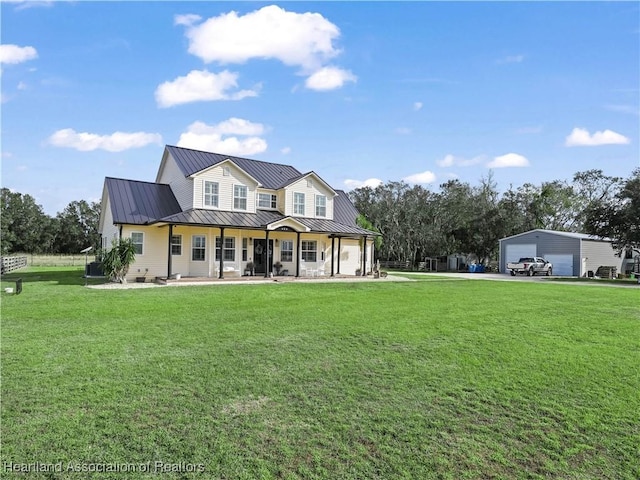 view of front of property with a front lawn, covered porch, and a garage