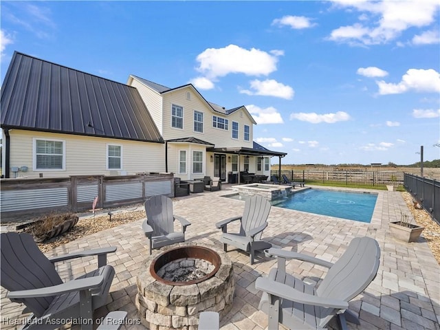 view of swimming pool with an outdoor living space with a fire pit, an in ground hot tub, and a patio