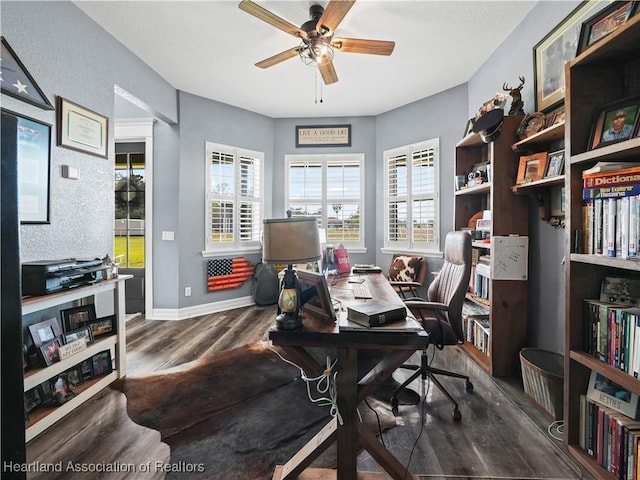 home office featuring ceiling fan and dark hardwood / wood-style flooring