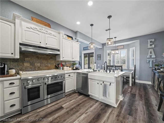 kitchen with white cabinetry, appliances with stainless steel finishes, and hanging light fixtures