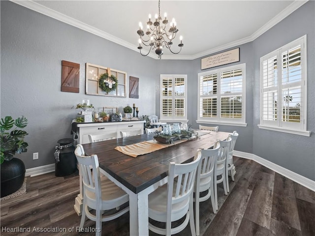 dining room featuring dark wood-type flooring, crown molding, and a chandelier