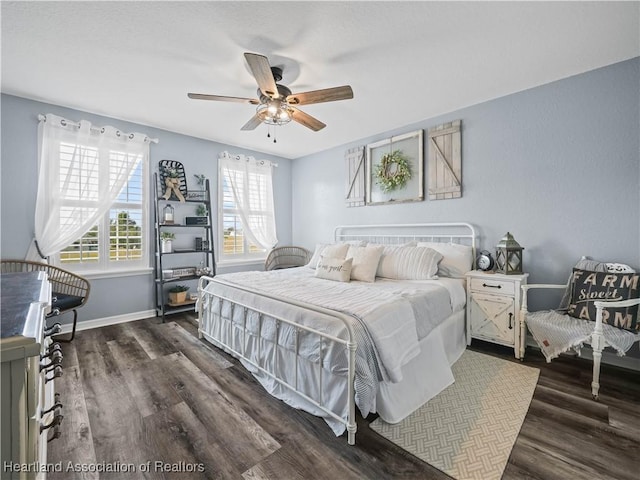 bedroom featuring ceiling fan and dark hardwood / wood-style floors