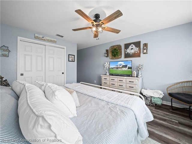 bedroom with ceiling fan, a closet, and dark hardwood / wood-style flooring