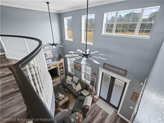 interior space with ceiling fan, dark hardwood / wood-style flooring, and ornamental molding