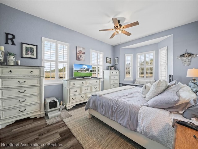 bedroom featuring ceiling fan and dark hardwood / wood-style floors