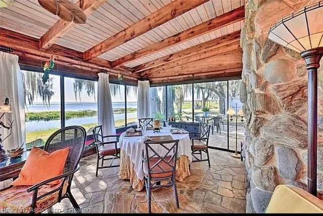 sunroom with wood ceiling, a water view, and vaulted ceiling with beams