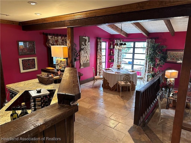 interior space featuring beamed ceiling and an inviting chandelier