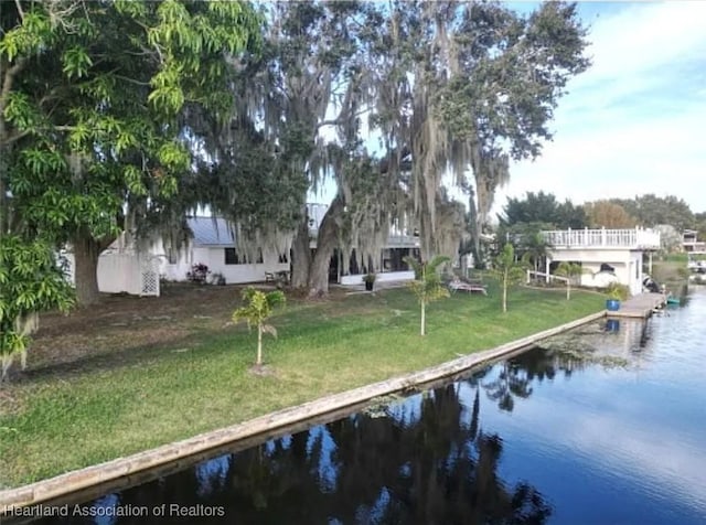 exterior space featuring a water view and a yard