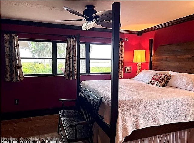 bedroom with ceiling fan and crown molding