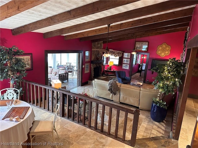 living room with vaulted ceiling with beams