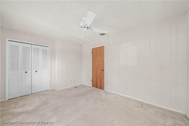 170 Parkview Cir, Lake Placid, FL 33852 - unfurnished bedroom with carpet flooring, a textured ceiling, a closet, a ceiling fan, and baseboards