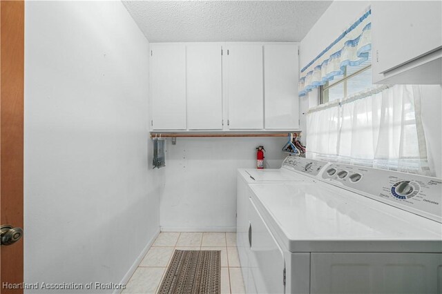 170 Parkview Cir, Lake Placid, FL 33852 - washroom featuring cabinet space, washer and dryer, a textured ceiling, baseboards, and light tile patterned floors