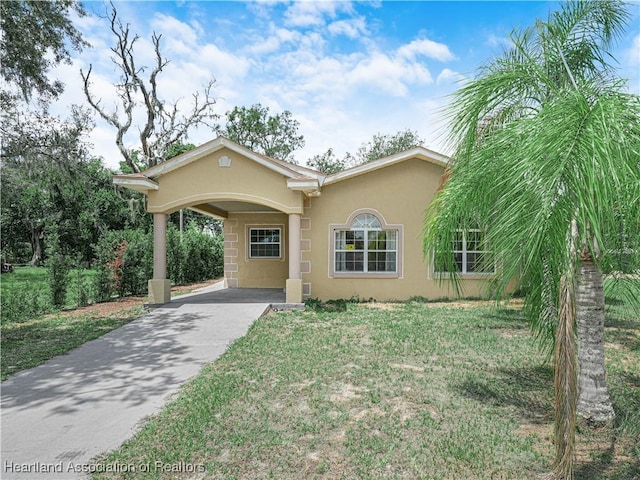 1621 Warfield Pl, Sebring, FL 33870 - view of front of home featuring stucco siding, a carport, and driveway