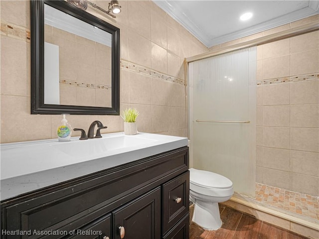 1621 Warfield Pl, Sebring, FL 33870 - bathroom with vanity, a stall shower, tile walls, wood finished floors, and crown molding