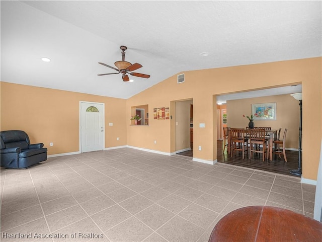 1621 Warfield Pl, Sebring, FL 33870 - unfurnished living room featuring a ceiling fan, vaulted ceiling, and light tile patterned flooring