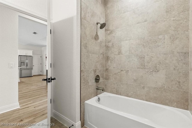 4954 San Ignacio Dr, Sebring, FL 33872 - bathroom with wood finished floors and shower / bathtub combination