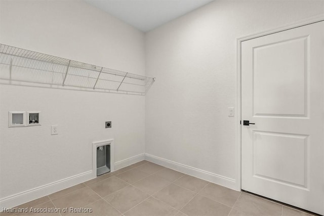 4954 San Ignacio Dr, Sebring, FL 33872 - laundry room with hookup for an electric dryer, hookup for a washing machine, and light tile patterned floors
