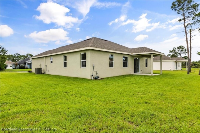 4954 San Ignacio Dr, Sebring, FL 33872 - rear view of house featuring stucco siding, a yard, roof with shingles, and a patio area