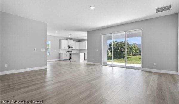 unfurnished living room with light hardwood / wood-style flooring