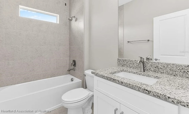 full bathroom with tiled shower / bath combo, vanity, and toilet