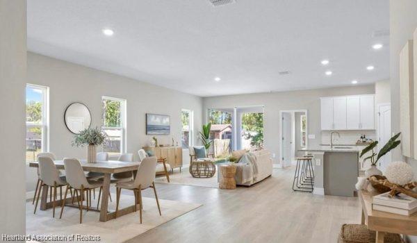 dining area featuring sink and light hardwood / wood-style flooring