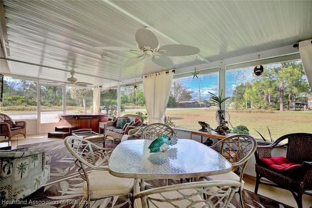 sunroom / solarium featuring ceiling fan