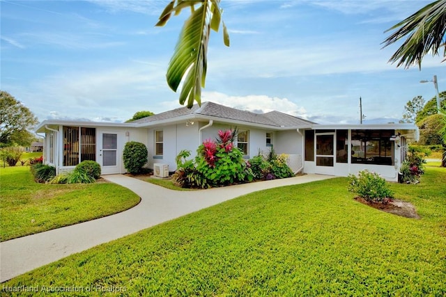 ranch-style house featuring a sunroom and a front lawn