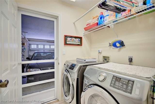 clothes washing area with washing machine and dryer