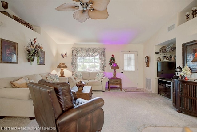 living room featuring ceiling fan, light colored carpet, and vaulted ceiling