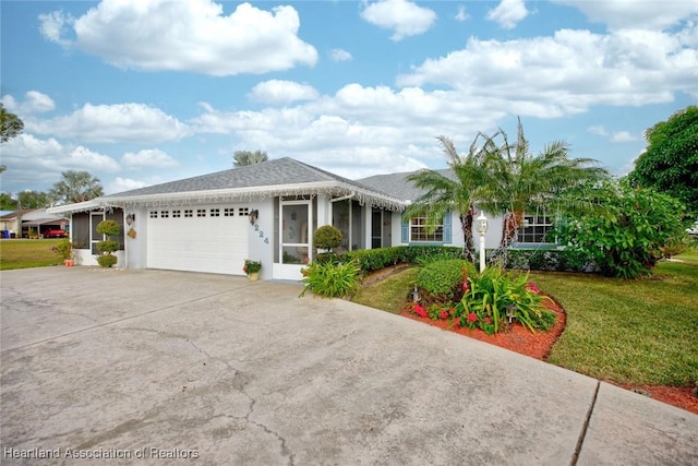 ranch-style house featuring a garage and a front yard