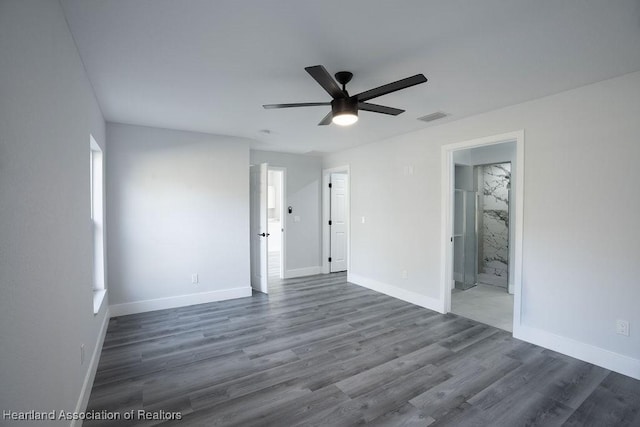 empty room featuring ceiling fan and dark wood-type flooring