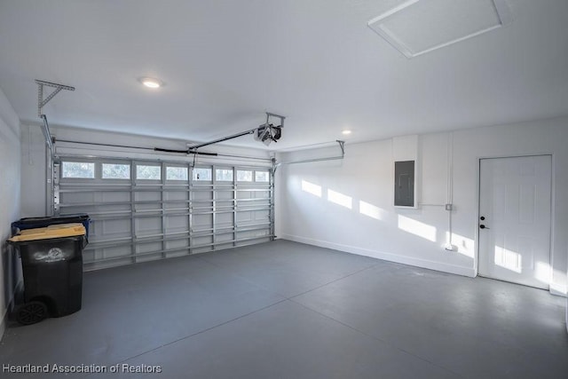 garage featuring electric panel and a garage door opener