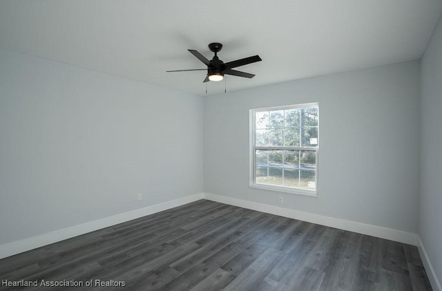 spare room featuring dark hardwood / wood-style floors and ceiling fan