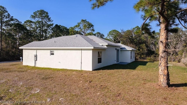 back of property featuring a lawn