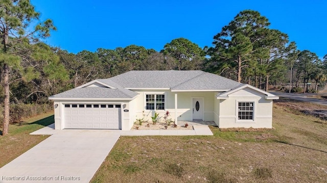 single story home featuring a front lawn and a garage