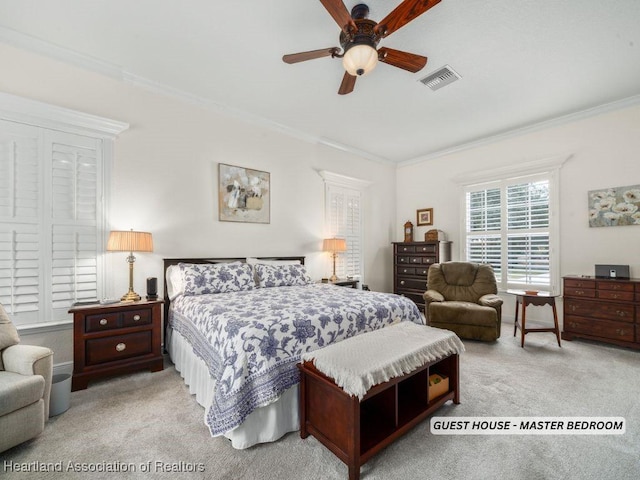 bedroom featuring light carpet, crown molding, and ceiling fan