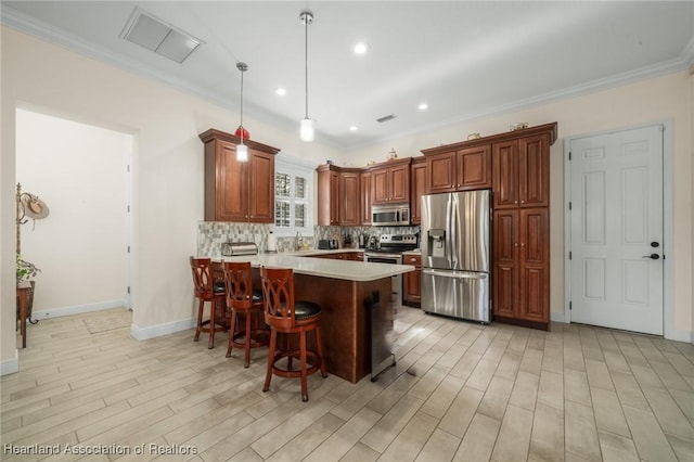 kitchen featuring pendant lighting, tasteful backsplash, a breakfast bar area, kitchen peninsula, and stainless steel appliances