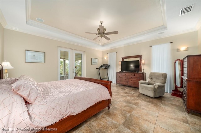 bedroom featuring a tray ceiling, french doors, ornamental molding, and ceiling fan