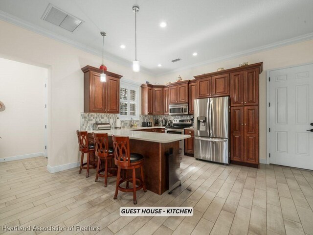 dining room featuring crown molding, a chandelier, and light wood-type flooring