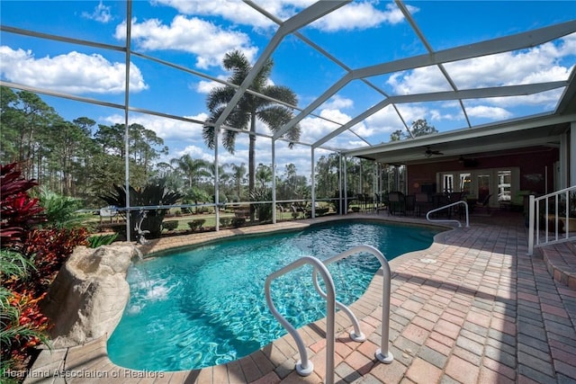 view of pool featuring ceiling fan, a lanai, a patio area, and pool water feature