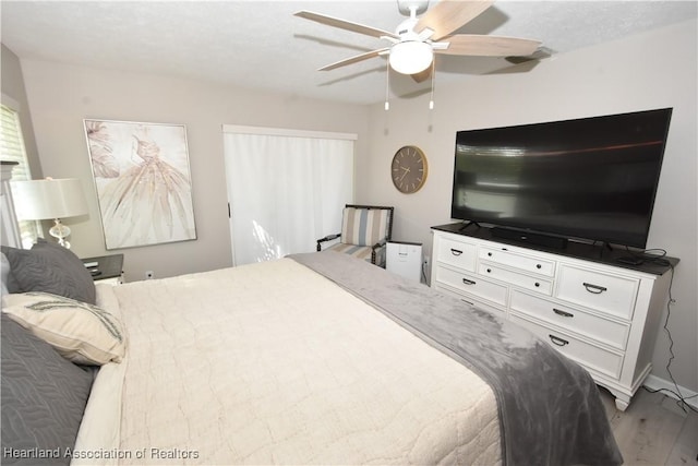 bedroom with ceiling fan and wood finished floors