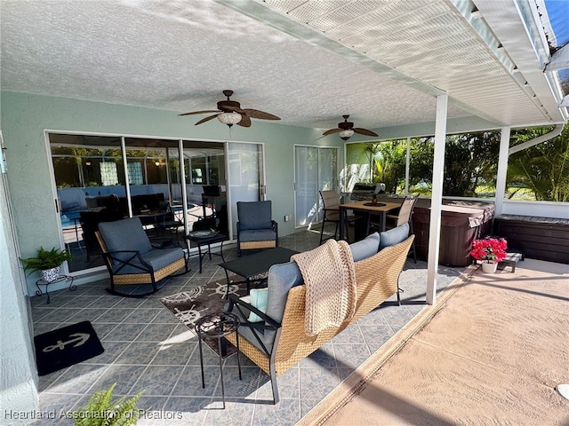 view of patio featuring a hot tub and ceiling fan