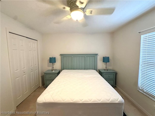 bedroom with carpet floors, a closet, and ceiling fan